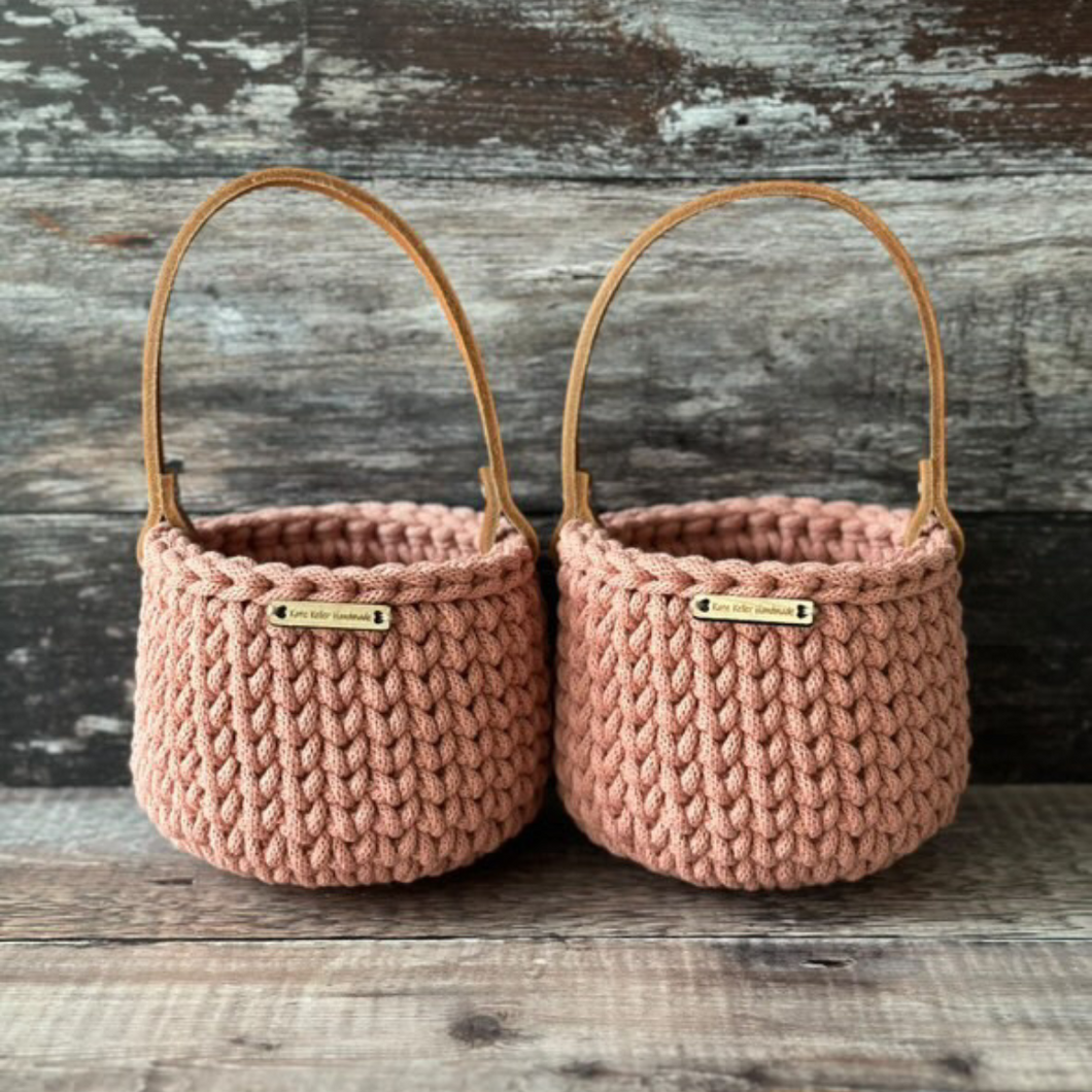 Handmade crochet easter basket in pastel pink on a wooden table