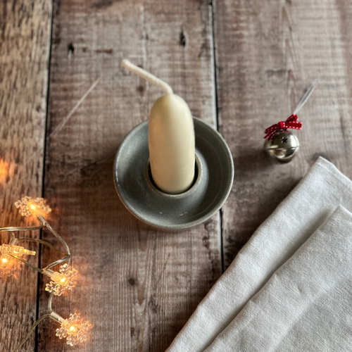 Handmade candle holder in pebble glaze with a stubby Wax Atelier Candle